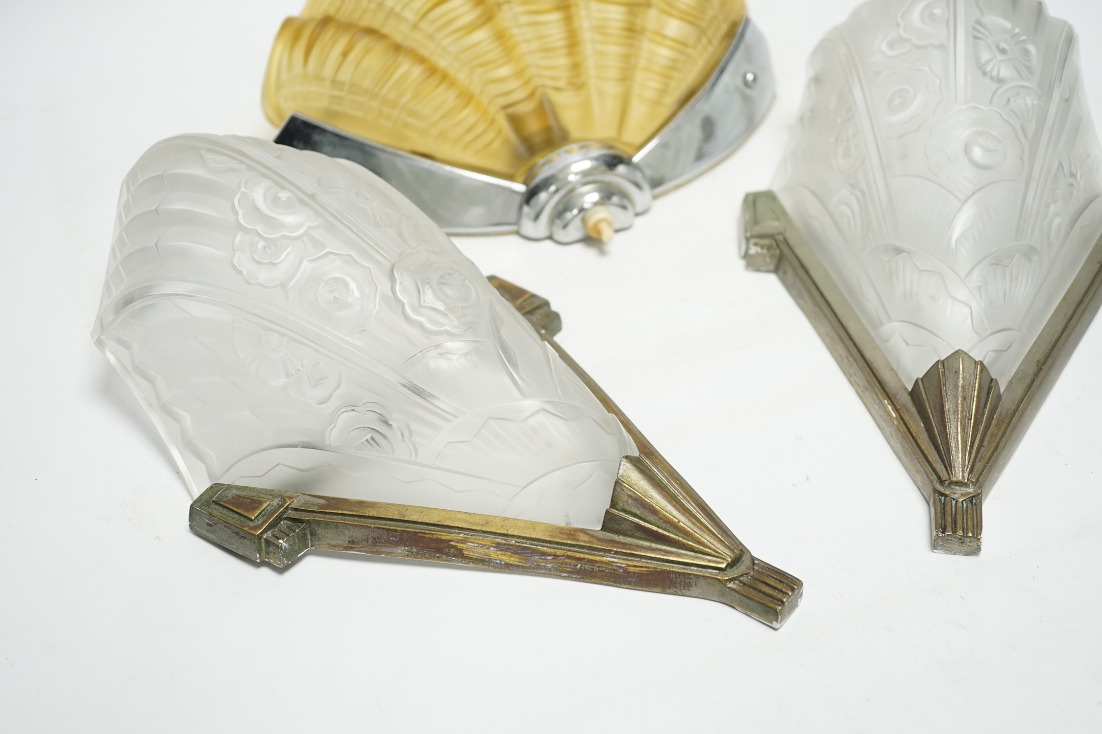 An Art Deco clam shell wall light and a pair of Art Deco wall lights, 30cm high (3). Condition - fair